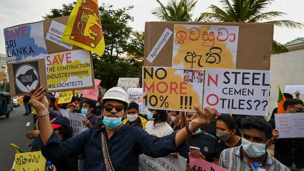 Protesters hold placards during an anti-government demonstration outside the Sri Lanka prime minister's official residence in Colombo on April 26, 2022, demanding President Gotabaya Rajapaksas resignation over the country's crippling economic crisis. (Photo by ISHARA S. KODIKARA / AFP)